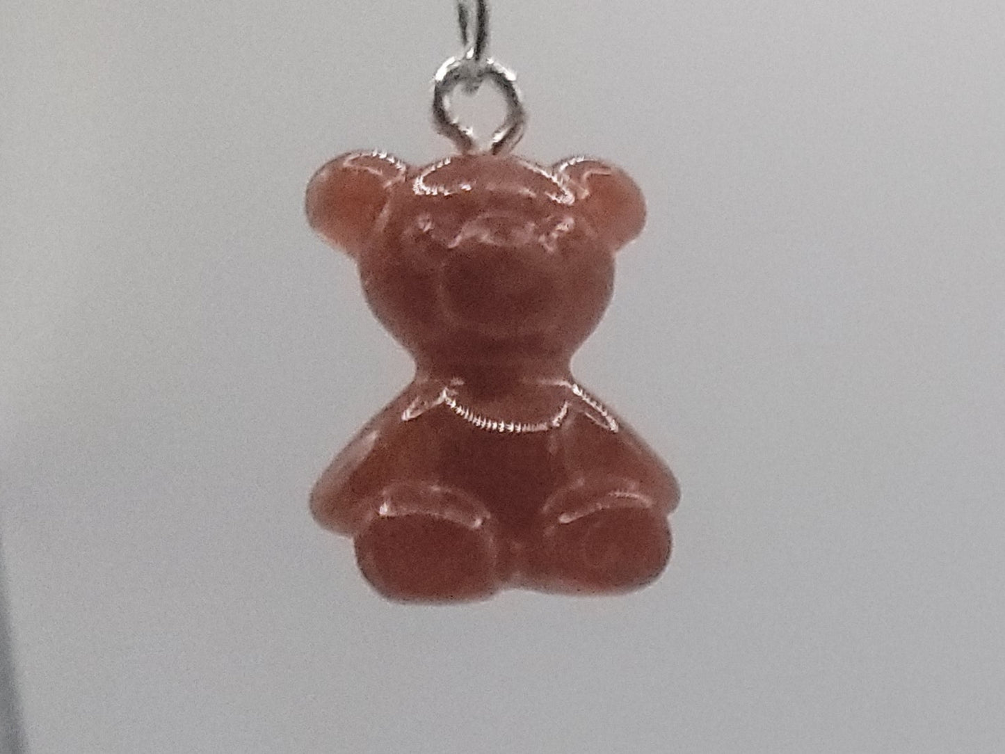 Red bear-shaped earrings on a white background