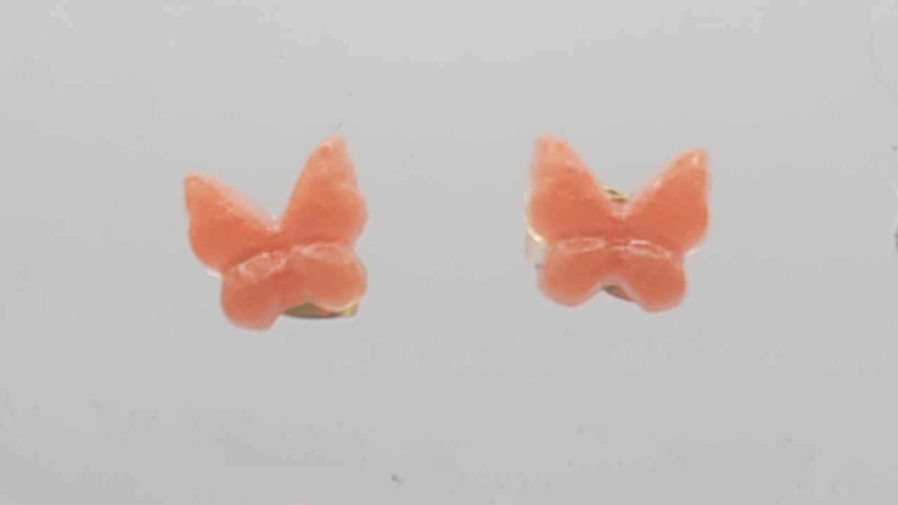 Butterfly-shaped earrings on a light gray background
