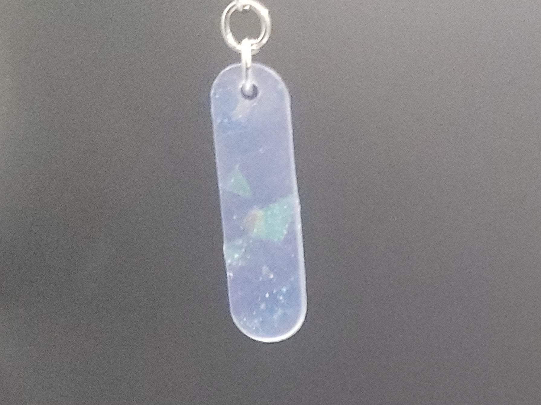 Opalite bar earrings on a dark gray background