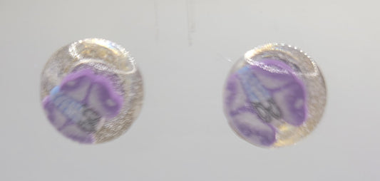 Set of colorful round earrings on a clear display stand.