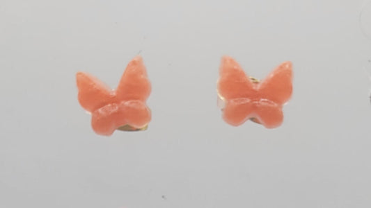 Butterfly-shaped earrings on a light gray background