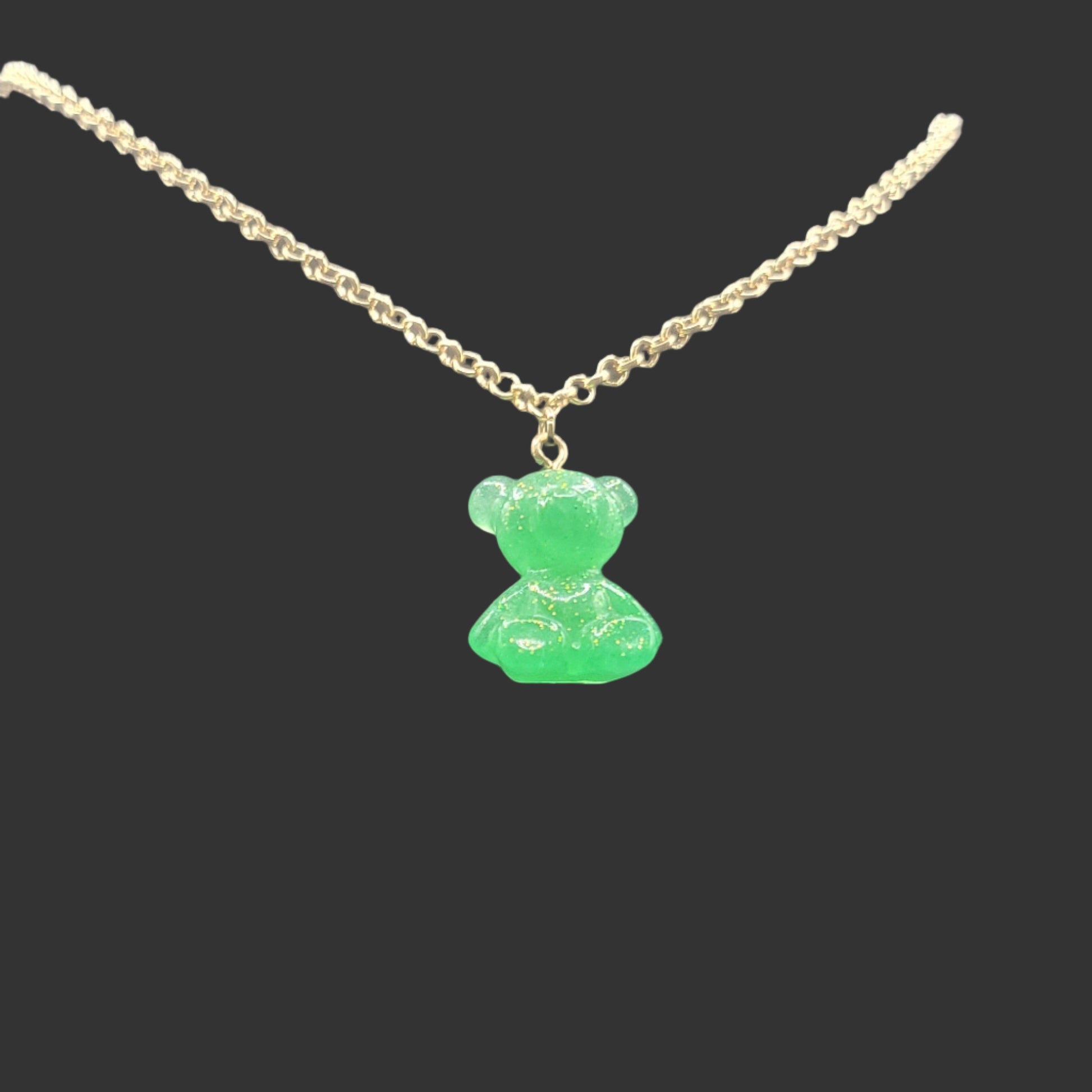 Necklace with a green teddy bear pendant suspended on a gold chain