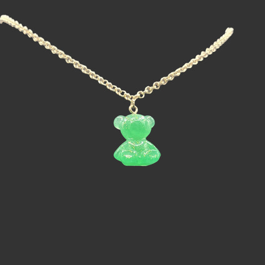 Necklace with a green teddy bear pendant suspended on a gold chain