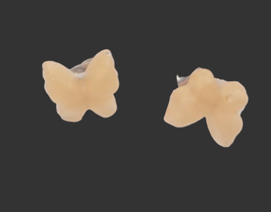 Butterfly-shaped earrings on a black background