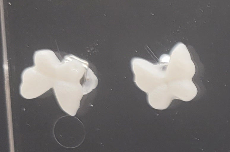 Butterfly-shaped earrings on a black background