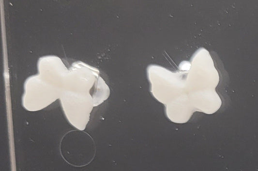 Butterfly-shaped earrings on a black background