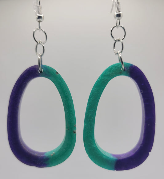 Oval-shaped earrings with gradient purple to green design on a white background