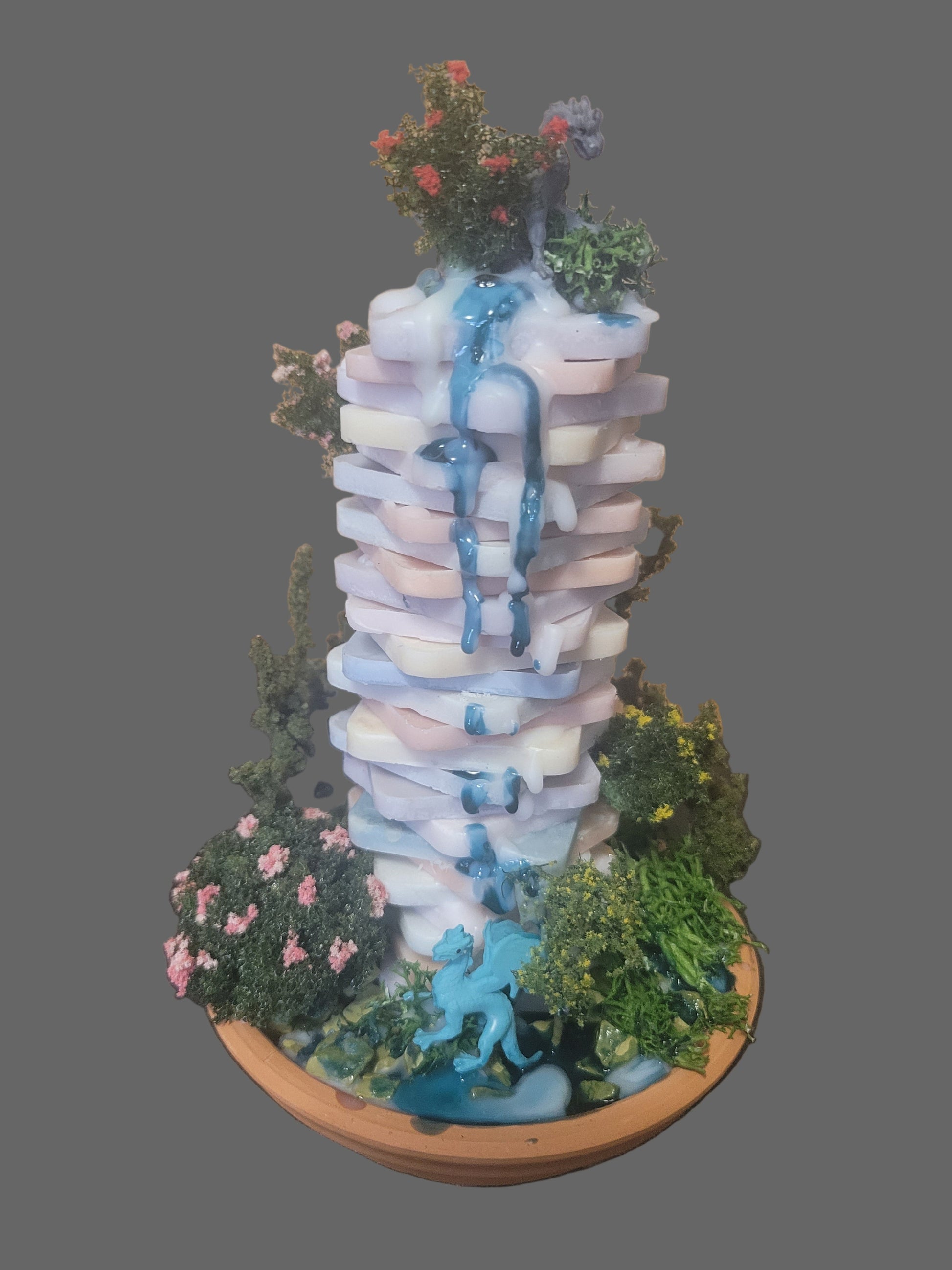 Fantasy scene with hand made offset tower candle. Dragons