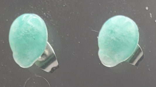 Pair of green stone earrings on a dark background